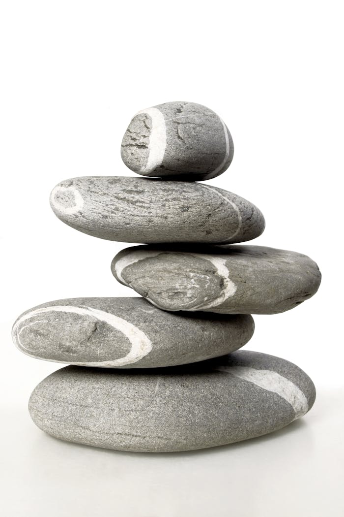 services-02 A serene stack of smooth, patterned stones symbolizing balance and tranquility.