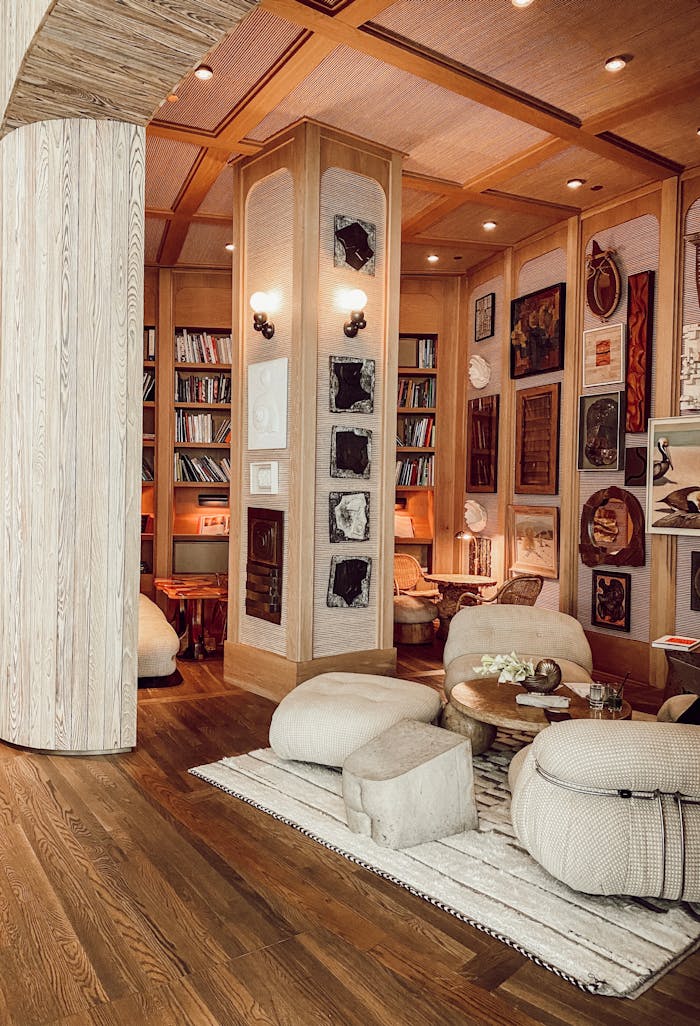 our-story-01 Cozy library room with plush seating and bookshelves in a luxury hotel.