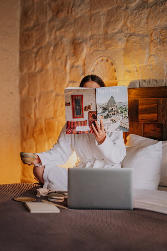 services-04 A woman enjoys a serene morning in a Cappadocia hotel, reading and relaxing.