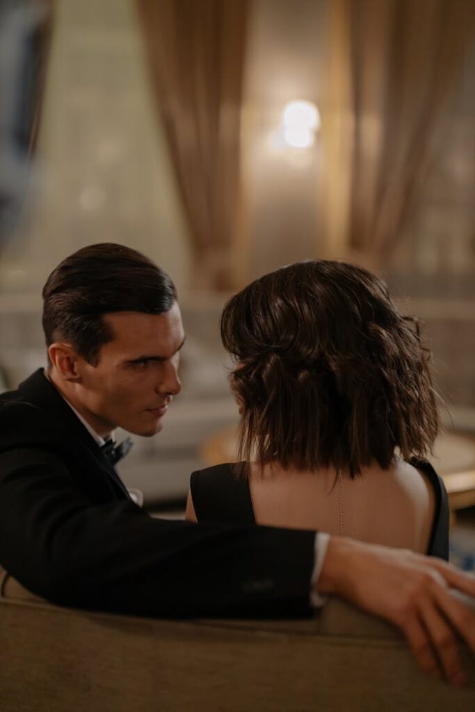 The Art of Drawing Readers In: Your attractive post title goes here A couple sitting in a luxurious, elegant environment, exchanging intimate glances and embracing.